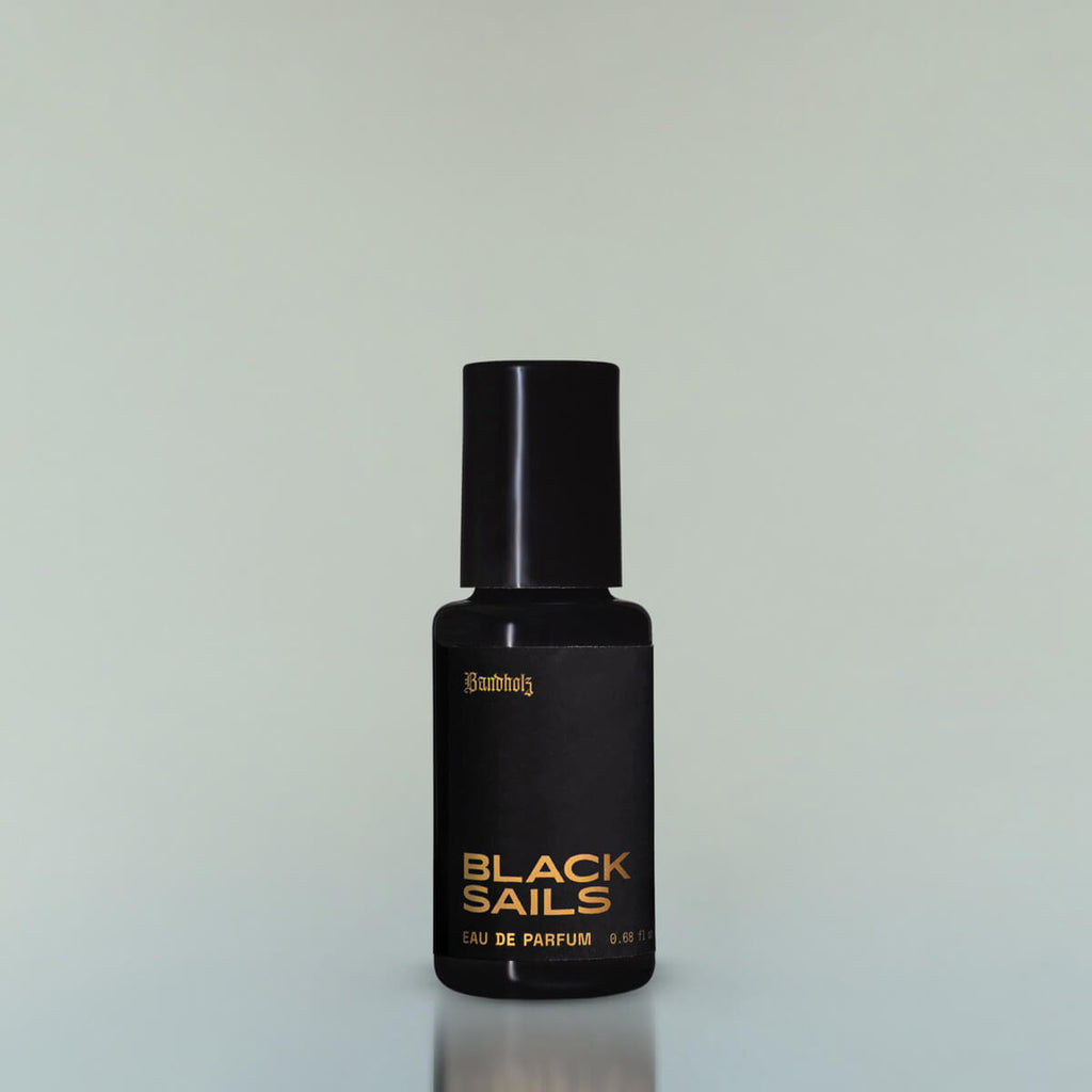 A bottle of Black Sails Eau de Parfum against a grey background.