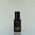 A bottle of Black Sails Eau de Parfum against a grey background.