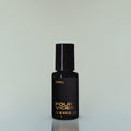 A bottle of Four Vices Eau de Parfum against a grey background.