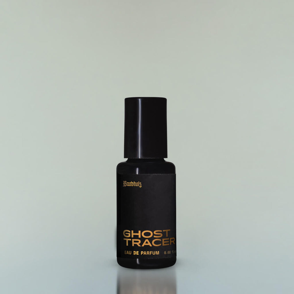 A bottle of Ghost Tracer Eau de Parfum against a grey background.