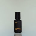 A bottle of Ghost Tracer Eau de Parfum against a grey background.