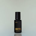 A bottle of Norse Winter Eau de Parfum against a grey background.