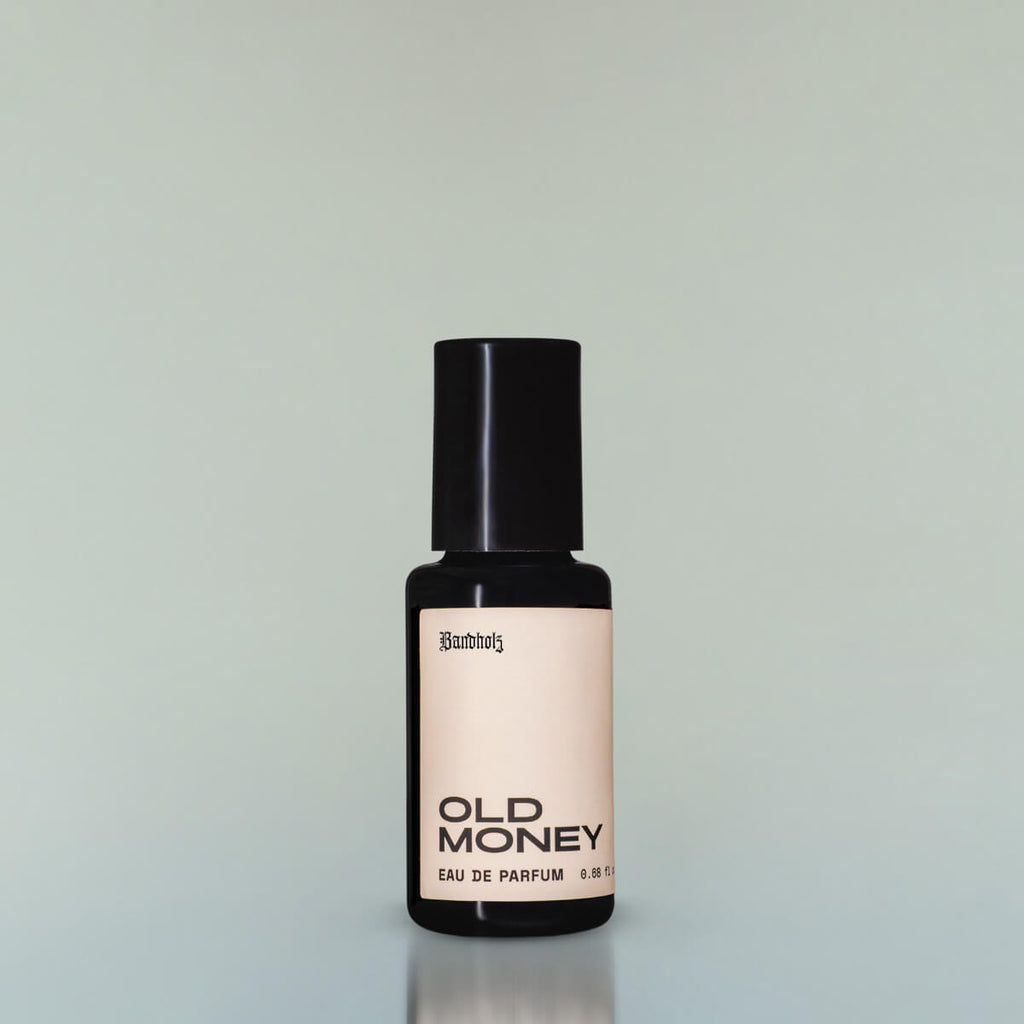 A bottle of Old Money Eau de Parfum against a grey background.