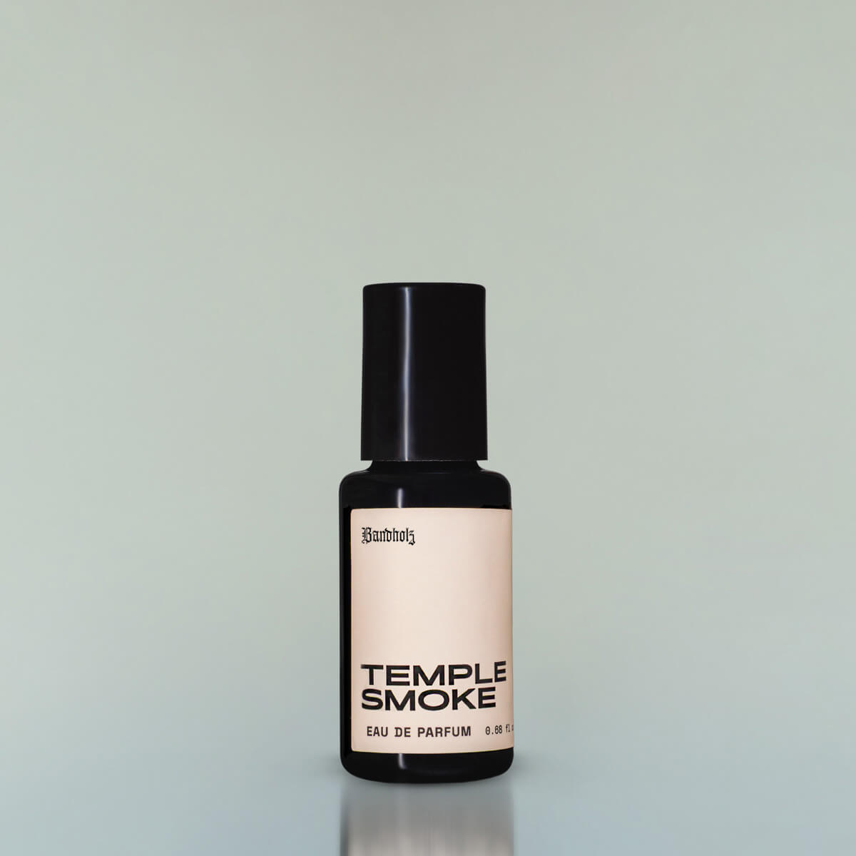 A bottle of Temple Smoke Eau de Parfum against a grey background.