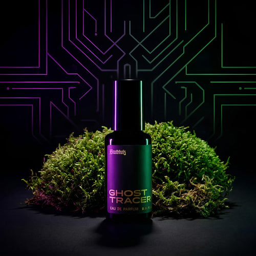 Ghost Tracer Eau de Parfum bottle by Bandholz placed in front of vibrant green moss with a neon circuit-style background. Image reflects a futuristic, earthy fragrance with notes of rain, moss, ozone, and violet leaf.